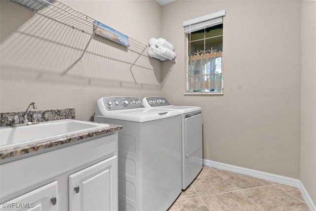 laundry area featuring cabinets, independent washer and dryer, sink, and light tile patterned floors