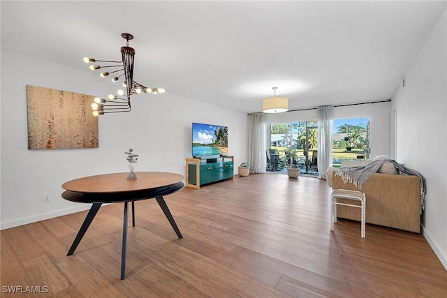 living room with hardwood / wood-style floors and a notable chandelier