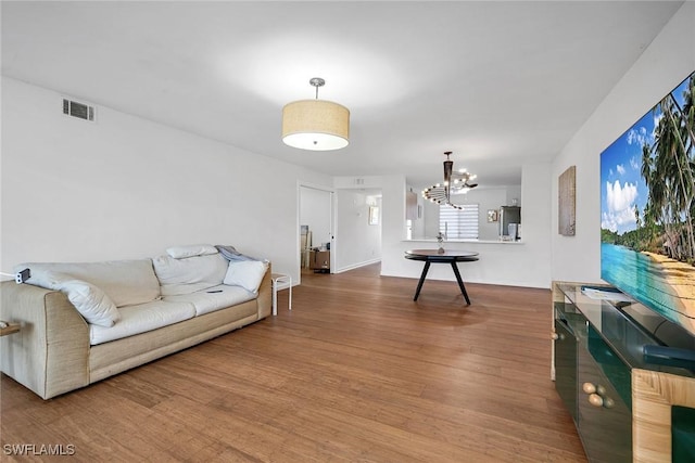 living room featuring hardwood / wood-style floors and an inviting chandelier