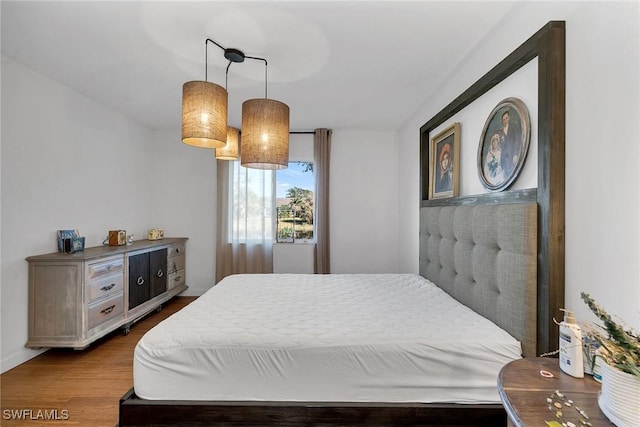 bedroom with wood-type flooring