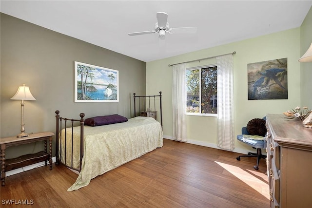 bedroom with ceiling fan and dark hardwood / wood-style floors