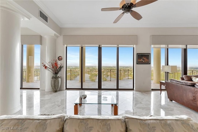 living room featuring a healthy amount of sunlight, ceiling fan, and crown molding