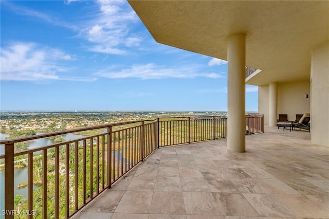 view of patio / terrace featuring a balcony and a water view