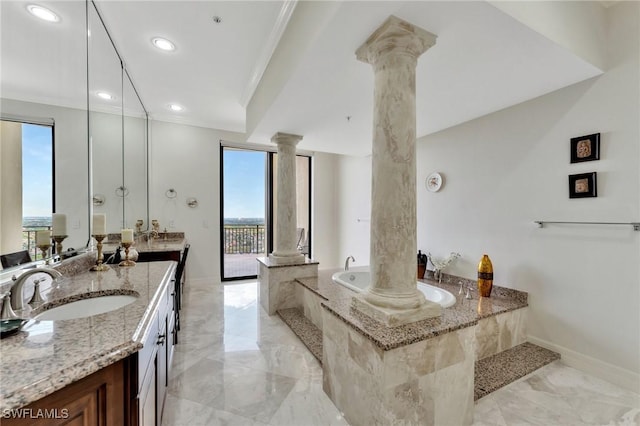 bathroom with decorative columns, vanity, ornamental molding, and a relaxing tiled tub