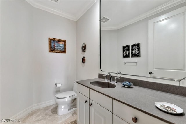 bathroom with vanity, toilet, and crown molding