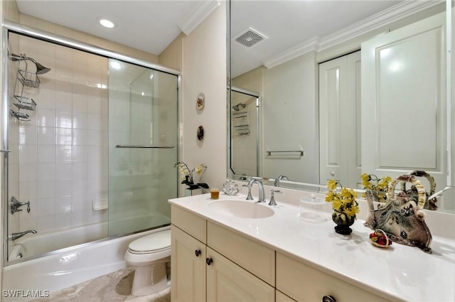 full bathroom featuring shower / bath combination with glass door, crown molding, vanity, and toilet