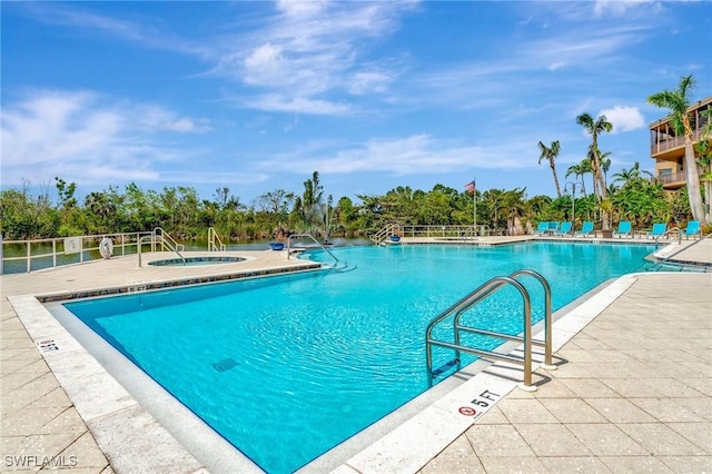 view of pool featuring a hot tub and a patio area