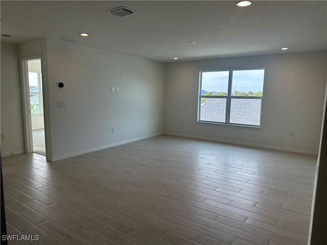 unfurnished room with light hardwood / wood-style flooring