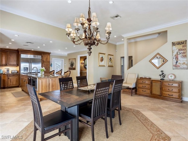 dining space with wine cooler, crown molding, sink, and a chandelier