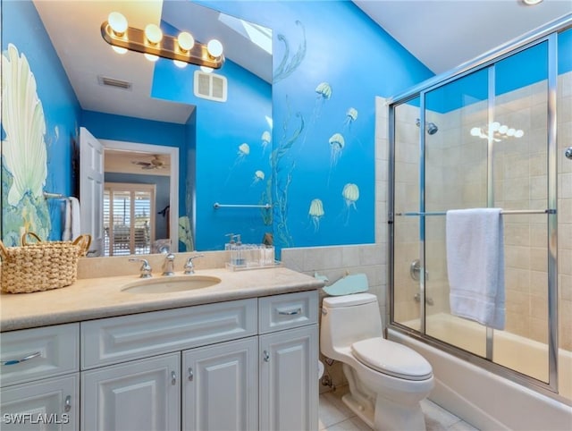 full bathroom featuring combined bath / shower with glass door, vanity, tile patterned floors, and toilet