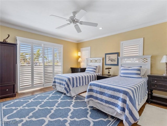 bedroom featuring hardwood / wood-style floors, ceiling fan, and ornamental molding