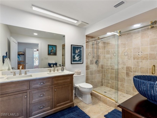 bathroom featuring vanity, toilet, and a shower with door