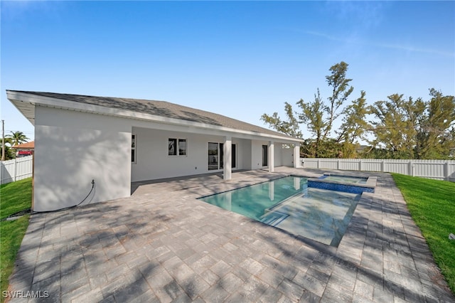 1027 NW 40th Pl, Cape Coral, FL 33993 - view of pool featuring a patio area, a pool with connected hot tub, and a fenced backyard