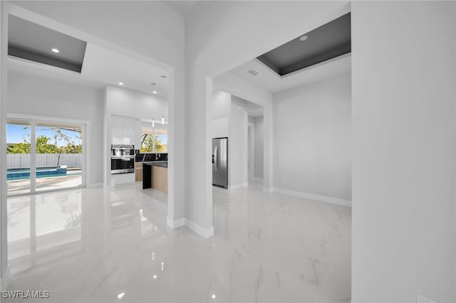 1027 NW 40th Pl, Cape Coral, FL 33993 - interior space featuring visible vents, baseboards, recessed lighting, a towering ceiling, and marble finish floor