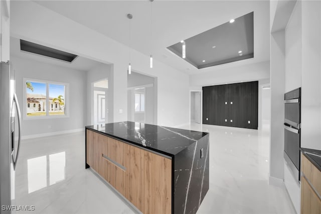 1027 NW 40th Pl, Cape Coral, FL 33993 - kitchen featuring dark stone countertops, stainless steel fridge, marble finish floor, modern cabinets, and a kitchen island