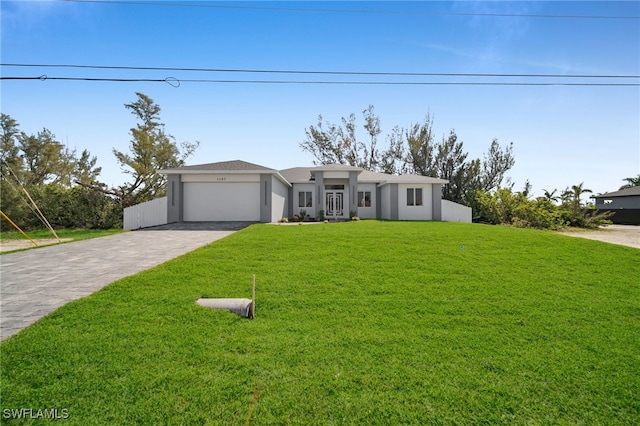 1027 NW 40th Pl, Cape Coral, FL 33993 - mid-century inspired home featuring a garage, driveway, stucco siding, and a front lawn