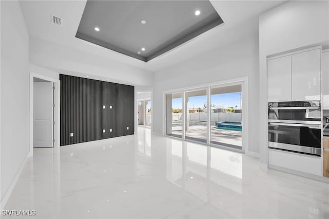 1027 NW 40th Pl, Cape Coral, FL 33993 - interior space with visible vents, recessed lighting, a high ceiling, marble finish floor, and a raised ceiling