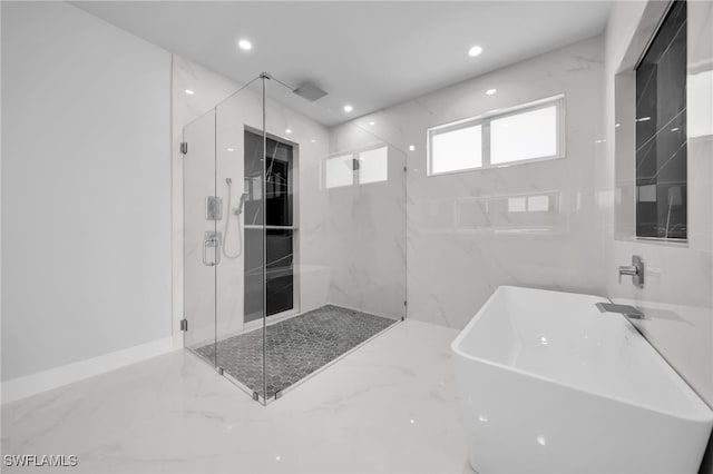 1027 NW 40th Pl, Cape Coral, FL 33993 - bathroom featuring a marble finish shower, a freestanding bath, marble finish floor, and recessed lighting