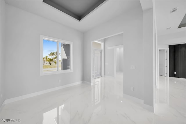 1027 NW 40th Pl, Cape Coral, FL 33993 - spare room with a tray ceiling, marble finish floor, baseboards, and visible vents