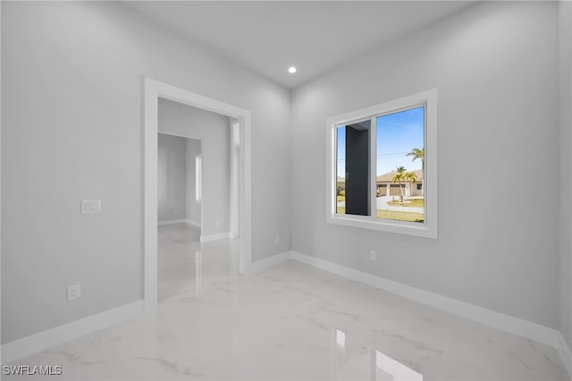 1027 NW 40th Pl, Cape Coral, FL 33993 - spare room featuring marble finish floor, baseboards, and recessed lighting