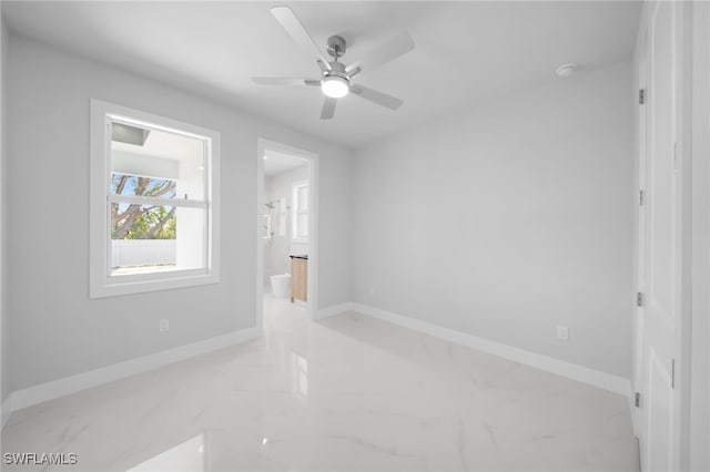 1027 NW 40th Pl, Cape Coral, FL 33993 - empty room featuring marble finish floor, baseboards, and ceiling fan