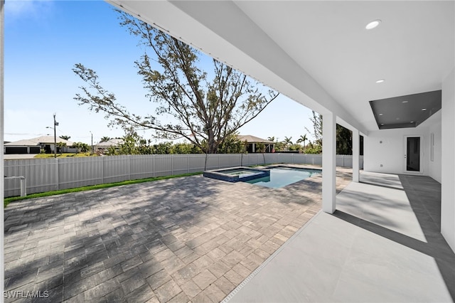 1027 NW 40th Pl, Cape Coral, FL 33993 - view of pool with a patio, a fenced backyard, and a pool with connected hot tub