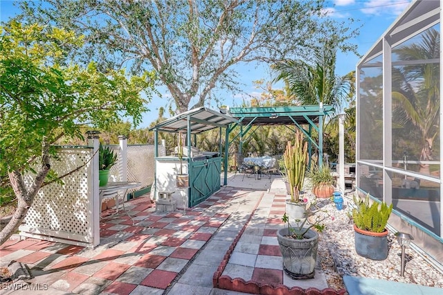 view of patio / terrace featuring a lanai