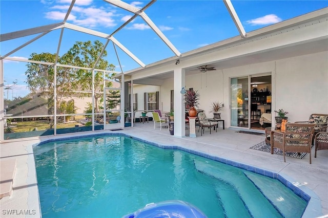 view of pool featuring a lanai, ceiling fan, and a patio area