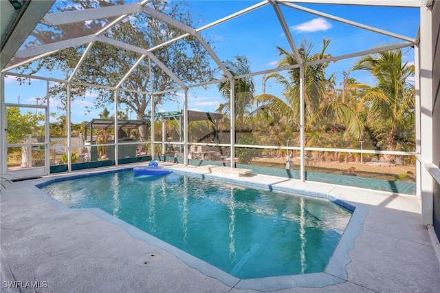 view of pool with a lanai and a patio area