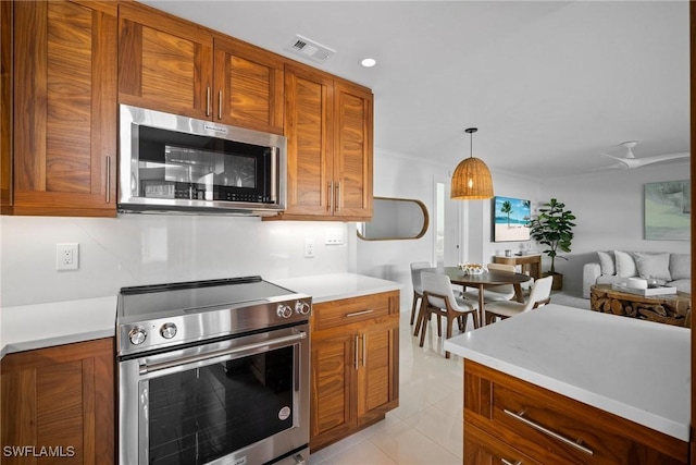 kitchen featuring pendant lighting, stainless steel appliances, light tile patterned floors, and ceiling fan