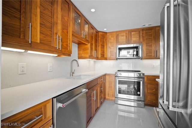 kitchen featuring sink, light tile patterned flooring, and stainless steel appliances