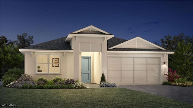 view of front of property featuring a yard and a garage