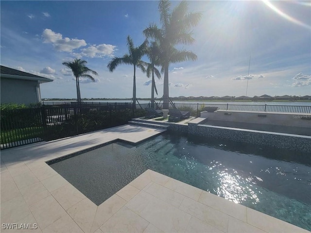 view of swimming pool featuring an in ground hot tub and a patio