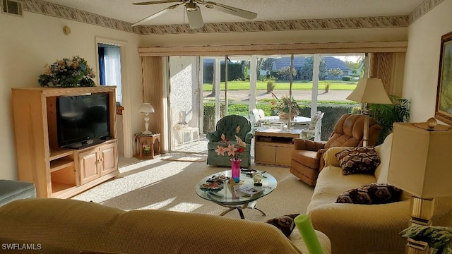 sunroom / solarium featuring ceiling fan, light colored carpet, and plenty of natural light