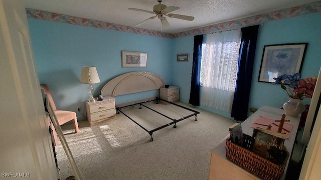 bedroom featuring ceiling fan and a textured ceiling