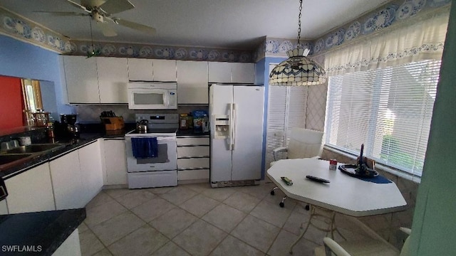 kitchen with white cabinetry, light tile patterned floors, ceiling fan, pendant lighting, and white appliances