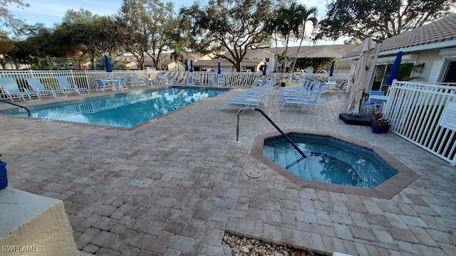 view of pool with a patio area and a community hot tub