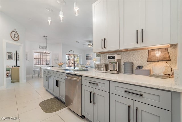 kitchen featuring dishwasher, lofted ceiling, hanging light fixtures, ceiling fan, and light stone countertops