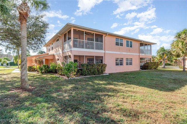 rear view of property with a yard