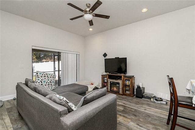 living room with ceiling fan and wood-type flooring