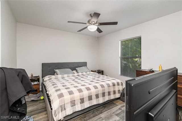 bedroom with hardwood / wood-style floors and ceiling fan