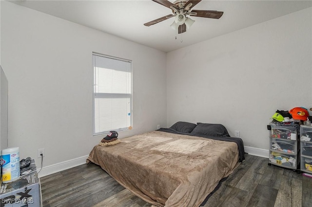 bedroom with dark hardwood / wood-style flooring and ceiling fan