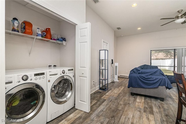 clothes washing area with ceiling fan, washer and clothes dryer, and dark wood-type flooring