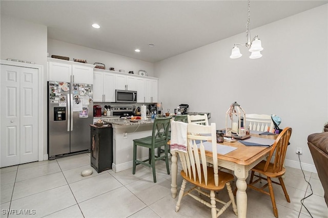 tiled dining space with an inviting chandelier