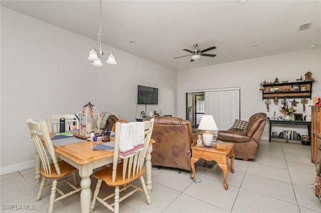 dining area featuring ceiling fan with notable chandelier and light tile patterned floors