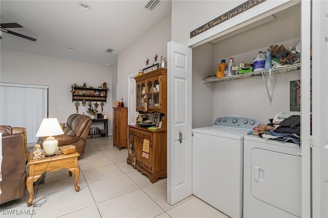 clothes washing area featuring ceiling fan, separate washer and dryer, and light tile patterned floors