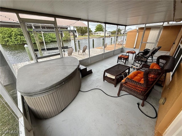 sunroom / solarium featuring a water view and plenty of natural light