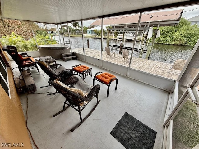 exterior space with a hot tub and a water view