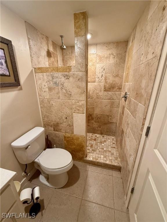 bathroom featuring toilet, vanity, and tiled shower