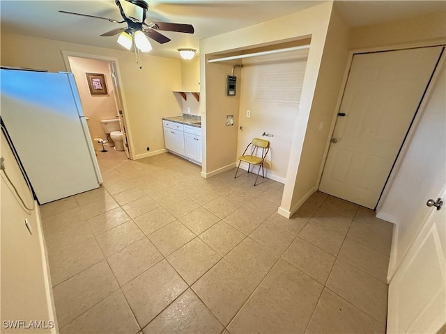 interior space with ceiling fan and light tile patterned floors